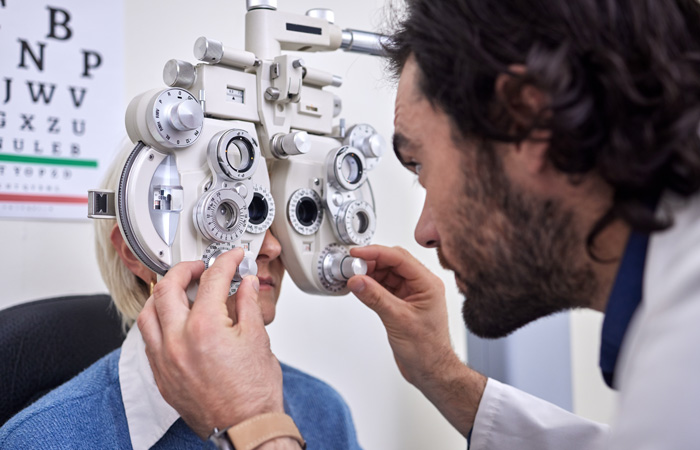 Doctor inspecting patients eyes