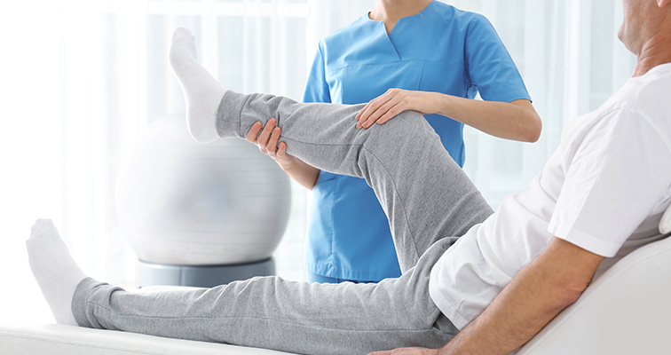 orthopedic doctor helping patient stretch